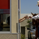 Mel Coleman, chairman of Coleman Natural Meats, sits atop a horse as he receives a hamburger from the drive-through window at Good Times Burgers & Frozen Custard in Denver, Colorado.